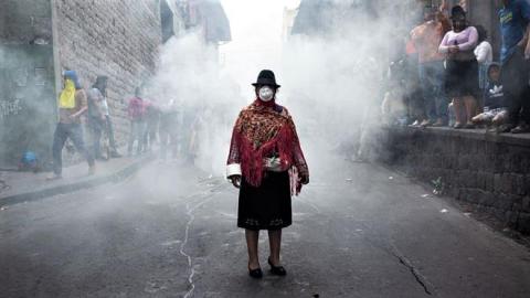 An indigenous woman wears a mask during a protest in Quito